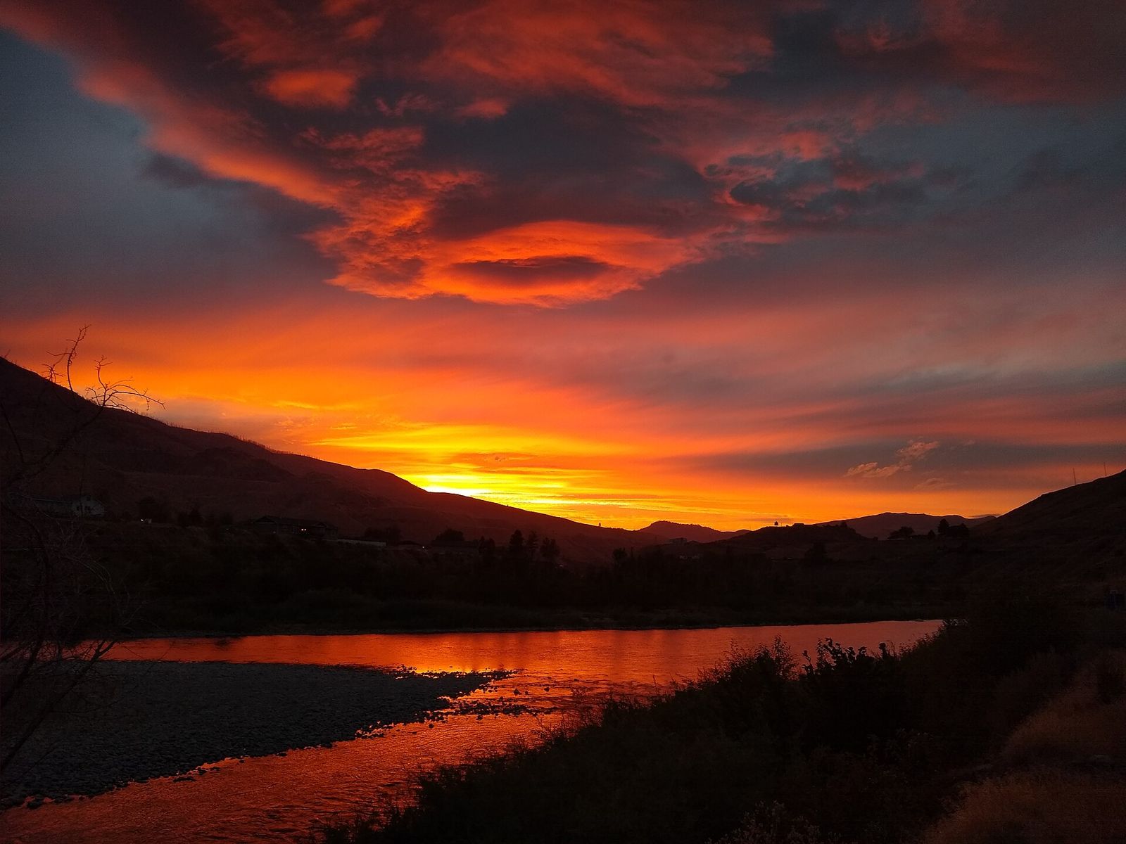 Fiery orange sunset over the Methow River near Pateros